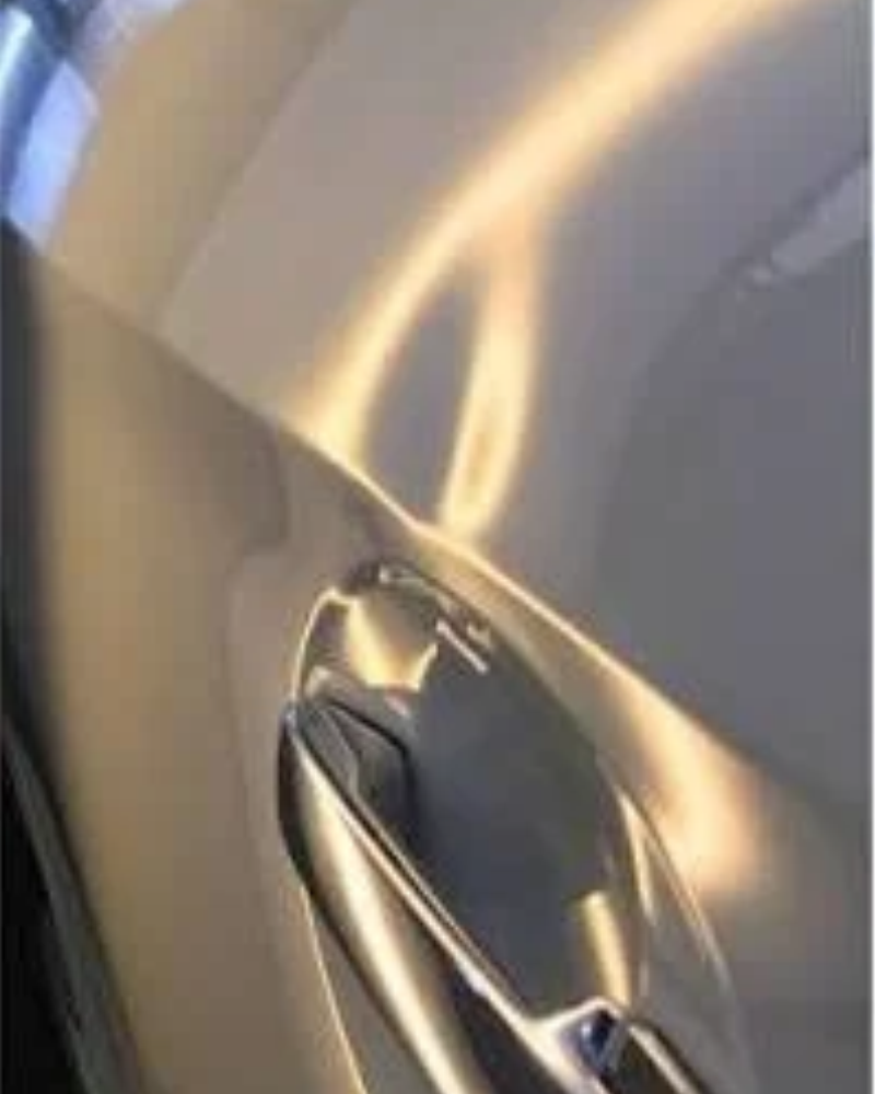 Before: Paintless dent repair on a car door