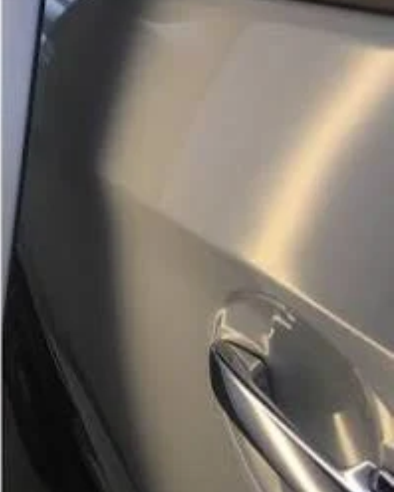 After: Paintless dent repair on a car door