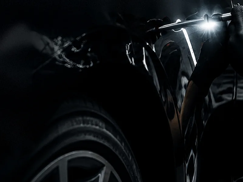 Car bonnet with hail damage dents before repair